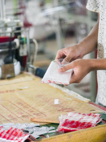 Person packing polypropylene PP Plastic bags into packs for sale