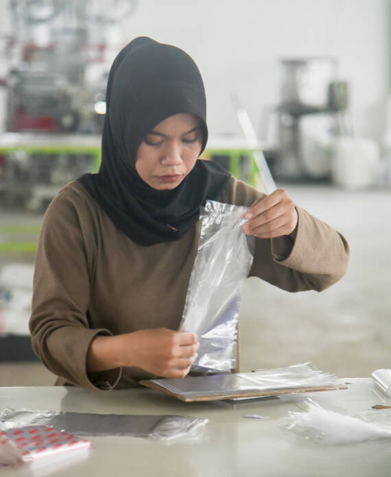 Person packing polypropylene plastic bags